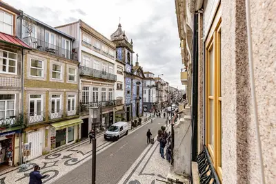 a city street with buildings and people walking down the street at YOUROPO - Capela in Porto