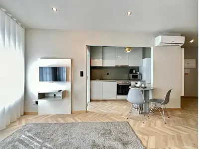 a kitchen with white cabinets and a table and chairs at YOUROPO - Capela in Porto