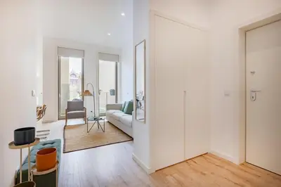 a living room with a white couch and a mirror at The Superior Green @ BoaVista Flats in Porto