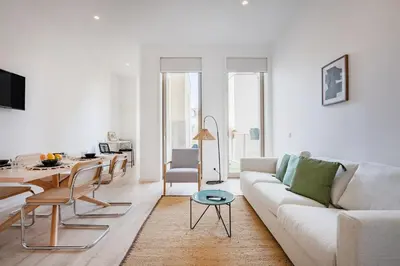 a white room with a chair and a table at The Superior Green @ BoaVista Flats in Porto