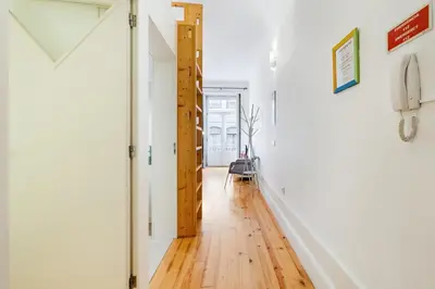 an open hallway with white walls and wooden floors at GuestReady - Dolce experience in Porto in Porto