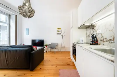 a living room with a couch and a kitchen at GuestReady - Dolce experience in Porto in Porto