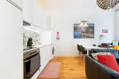 a kitchen and living room with a couch and a table at GuestReady - Dolce experience in Porto in Porto