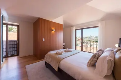 a kitchen with white walls and a wooden counter top at Porto Riverviews | Monte dos Judeus in Porto