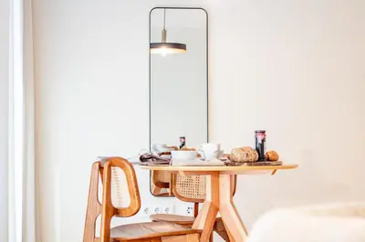 a table with a plate of food and a lamp at Luxurious Studio Retreat in Porto by LovelyStay in Porto