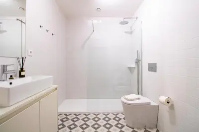 a bathroom with a toilet and a sink and a shower at Luxurious Studio Retreat in Porto by LovelyStay in Porto
