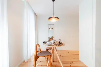 a table in a room with a chair and a mirror at Luxurious Studio Retreat in Porto by LovelyStay in Porto