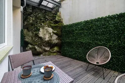 a table with two cups and a fan on a patio at WHome Modern Studio in Santa Catarina in Porto