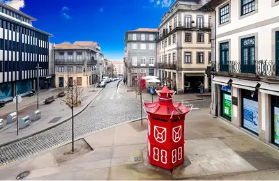 a living room with a table and a window at Oporto Blue Miragaia - Central Apartment With Charm in Porto