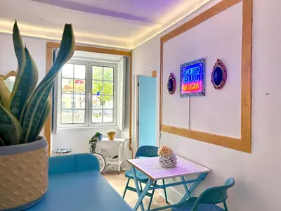 a living room with a table and a potted plant at Oporto Blue Miragaia - Central Apartment With Charm in Porto