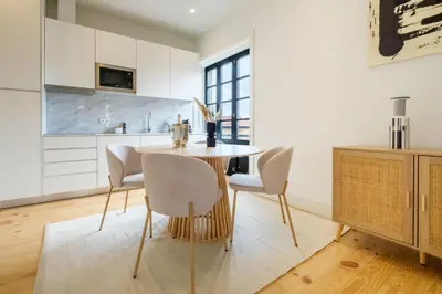 a kitchen with a table and chairs in a room at Art Deco 32 Luxury 2BR Apartment Downtown Metro AC in Porto