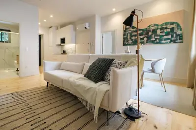 a living room with a white couch and a table at Art Deco 13 Luxury 2BR Apartment Downtown Metro AC in Porto