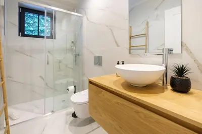 a bathroom with a sink and a shower at Art Deco 13 Luxury 2BR Apartment Downtown Metro AC in Porto