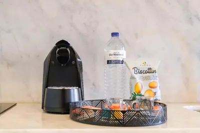 a bottle of water sitting next to a basket of fruit at Art Deco 33 Luxury 2BR Apartment Downtown Metro AC in Porto