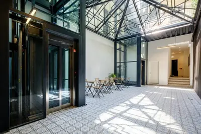 an internal view of a building with glass doors and a patio at Art Deco 12 Luxury 2BR Apartment Downtown Metro AC in Porto