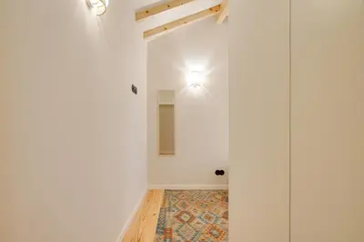 a hallway with white walls and a ceiling with a light at Figueirôa Four Houses by DA'Home in Porto