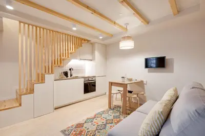 a living room with a couch and a table and a kitchen at Figueirôa Four Houses by DA'Home in Porto