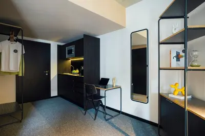 a bedroom with a bed and a desk and a chair at The Social Hub Porto Extended Stay in Porto