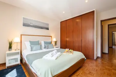 a bedroom with a large bed with towels on it at Bright & Spacious Flat by Host Wise in Porto