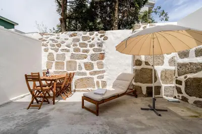 a bedroom with two beds with blue sheets at HostWise - Traditional House with Terrace in Porto