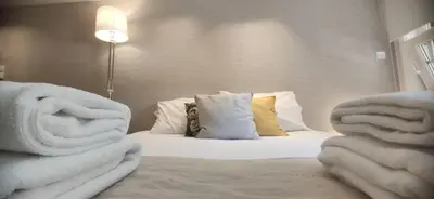 a hotel room with a bed with towels on it at Stay in Apartments Ribeira 24 in Porto
