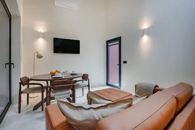 a living room with a couch and a table at Minimalist Loft @ Terracotta Collection in Porto