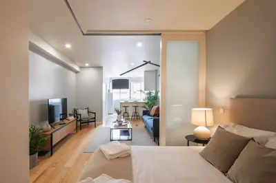a bedroom with a bed and a living room at Porto Insight Apartments - Belomonte in Porto