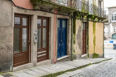 a row of doors on a building on a street at Porto Insight Apartments - Belomonte in Porto