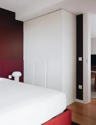 a bedroom with a white bed and a red stool at Flair Living in Vila Nova de Gaia