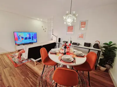 a living room with a table and chairs and a television at OPO Ribeira I in Porto