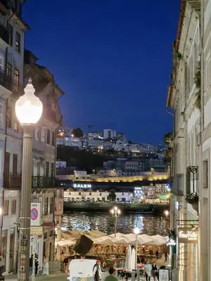 a street light with a view of a city at night at OPO Ribeira II in Porto