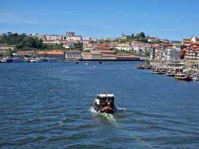 a small boat in a large body of water at OPO Ribeira II in Porto
