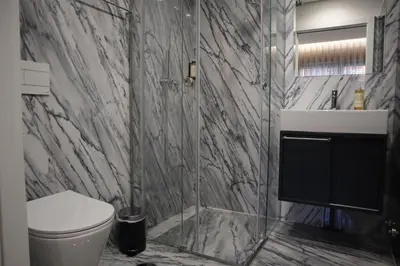 a bathroom with a toilet and a glass shower at RS Porto Central Apartments in Porto