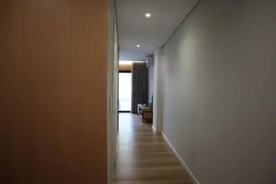 a hallway with white walls and a wooden floor at RS Porto Central Apartments in Porto