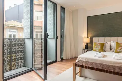 a bedroom with a bed and a large window at Liiiving in Porto - The Prestige Apartment A in Porto