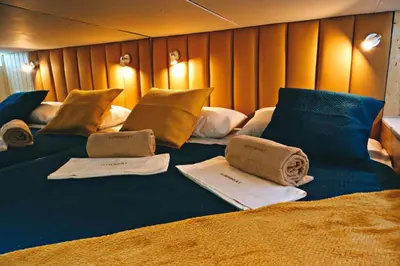 a large bed with towels and pillows on it at SLEEPBOAT Golden Life in Porto