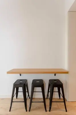 a wooden table with two stools under it at Liiiving in Porto - Crystal Luxury Apartment in Porto