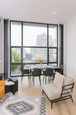 a living room with a table and a large window at Liiiving in Porto - Crystal Luxury Apartment in Porto