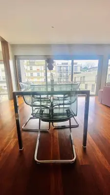 a glass table with a vase on top of a wooden floor at VER Torrinha -Porto in Porto