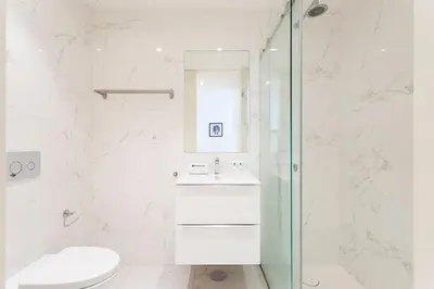 a bathroom with a toilet and a sink and a shower at Studio w/ Terrace, Pool & Gym | Antas by Host Wise in Porto