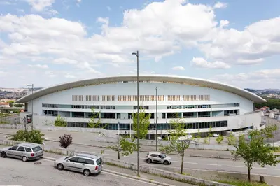 a large building with cars parked in front of it at Studio w/ Terrace, Pool & Gym | Antas by Host Wise in Porto
