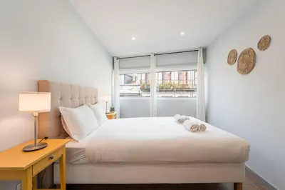 a bedroom with a bed with a desk and a window at GuestReady - Homely retreat in the city centre in Porto