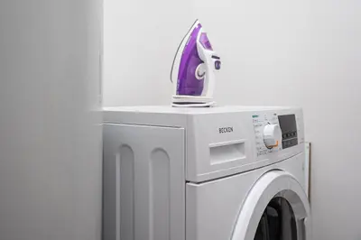 a iron is sitting on top of a washing machine at GuestReady - Homely retreat in the city centre in Porto