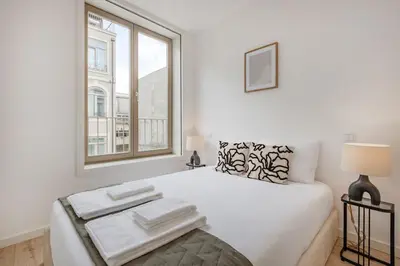 a white kitchen with a stove and a balcony at The Prime Loft @ BoaVista Flats in Porto