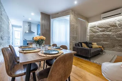 a dining room and living room with a table and chairs at ApartmentsPorto - Porto Dukes House in Porto