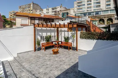 a patio with a table and benches on a building at HostWise - Quinta do Vintém w/ Terrace near WOW in Vila Nova de Gaia