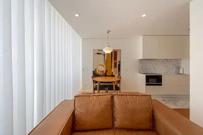 a living room with a brown couch and a table at 5daMaria - Porto Center in Porto