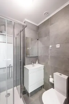 a bathroom with a shower and a toilet and a sink at VIVA Cozy Nest Studio Porto in Porto
