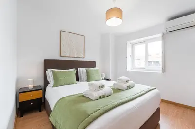 a bedroom with a large bed with towels on it at GuestReady - Invicta Porto Guest House in Porto