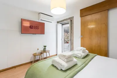 a bedroom with a bed with white towels on it at GuestReady - Invicta Porto Guest House in Porto